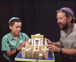 Father and son with completed Temple Model Kit